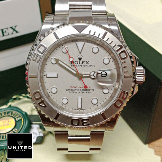 Rolex Yacht Master Platinum Dial Steel Replica next to warranty card